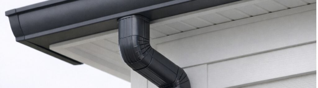 black-gutter-against-white-siding