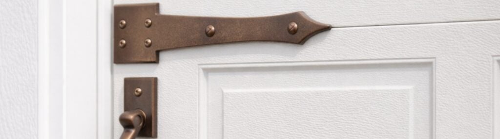 copper-door-hing-against-white-door